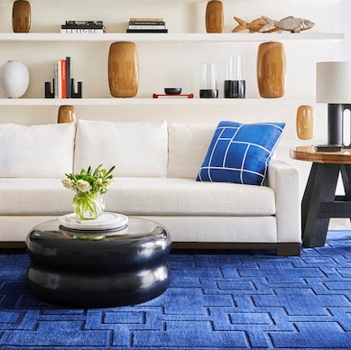 Living room with carved blue geometric rug